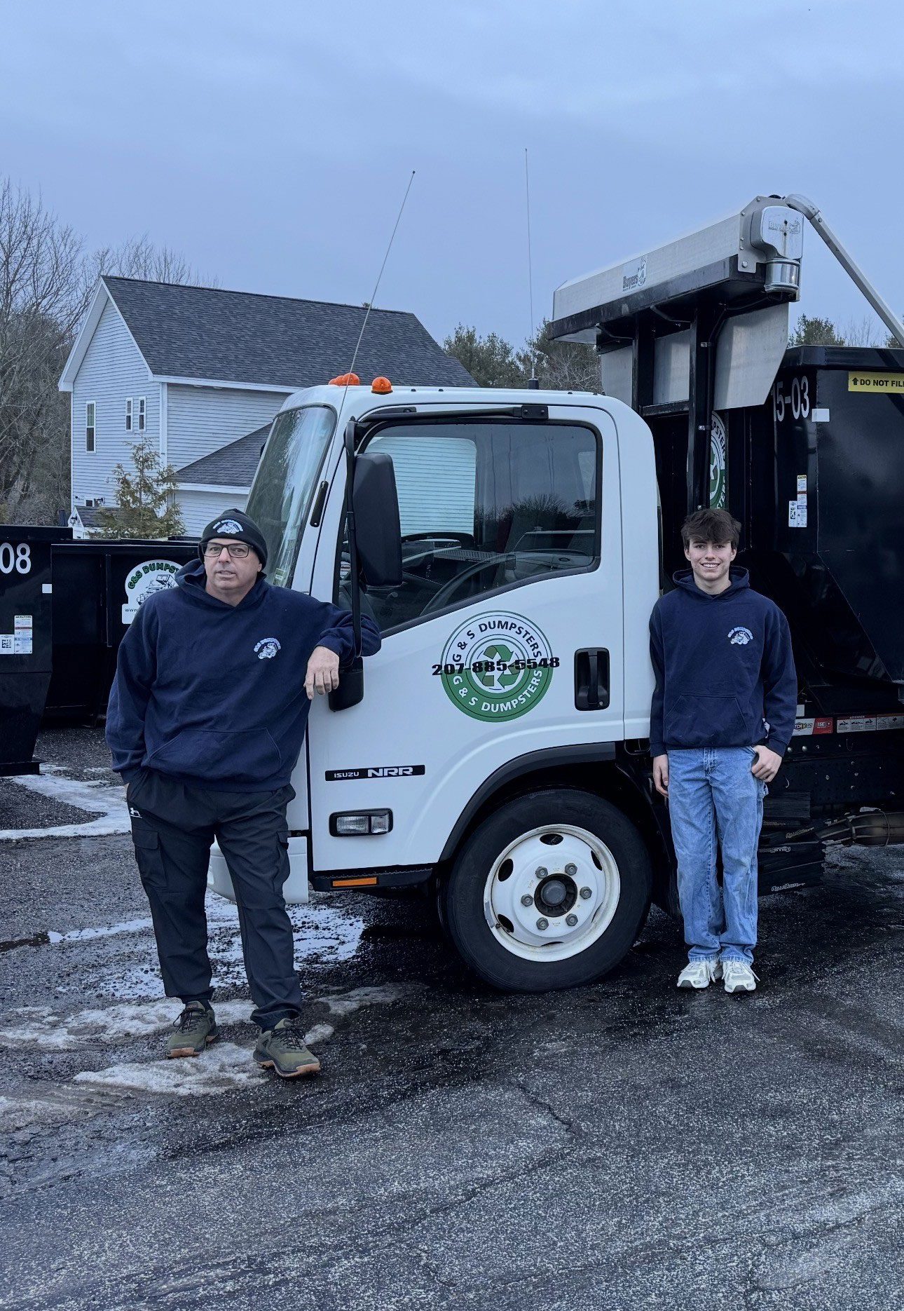 Dumpster filled with siding